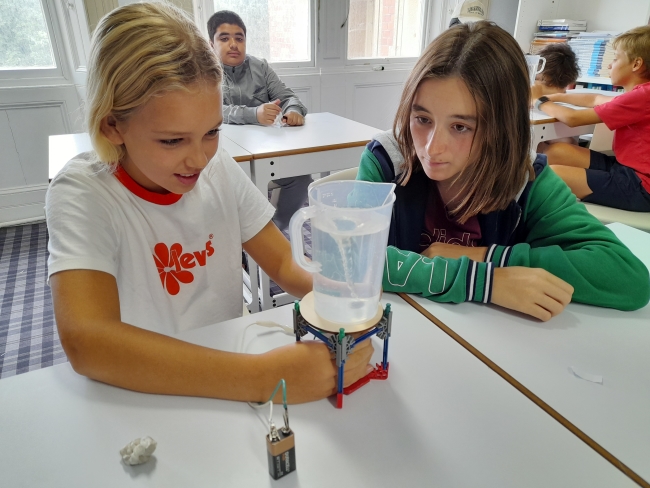 3-students-creating-water-tornado