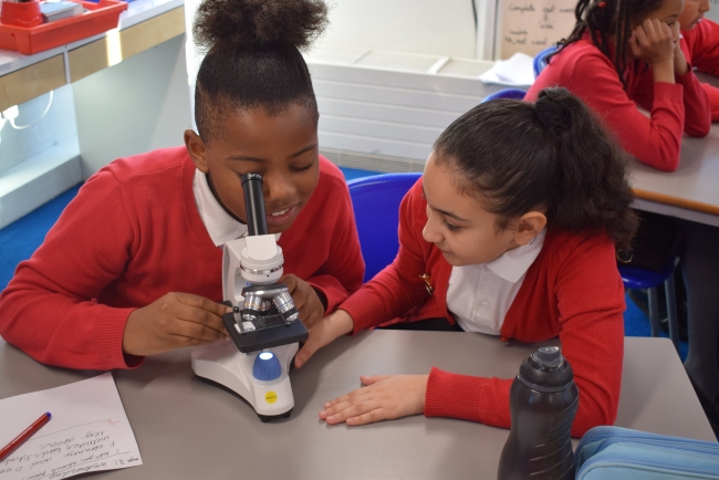 children-looking-through-microscope